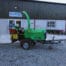 An Arborist 150 6″ Road Towed Wood Chipper in green is parked outside Killen Tool & Hire, a popular tool hire spot in Newry, with several wheelbarrows lined up nearby.