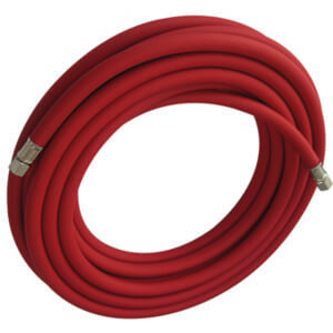 A coiled red rubber hose with metal connectors on both ends, available for tool hire Newry, placed against a white background.