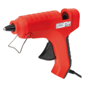 A red and black electric hot glue gun with a metal stand, labelled with safety symbols, is shown against a white backgroundโperfect for craft projects or available through tool hire Newry.