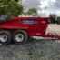 A red Tuff Mac DT14 Dump Trailer labelled "KILLEN Tools & Hire" and advertising tool hire Newry is parked on gravel near trees and a metal gate under a cloudy sky.