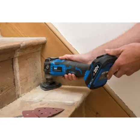 Draper Storm Force® 20V Oscillating Multi-Tool (Sold Bare)-3 Someone sands the edge of a wooden stair tread using a Draper Storm Force® 20V Oscillating Multi-Tool (Sold Bare); sanding pads are nearby—perfect for anyone seeking tool hire in Newry for woodworking projects.