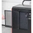 A person removes the mesh filter from a black Sealey 70L Industrial Dehumidifier SDH70, revealing its control panel and ventilation grille—ideal equipment for tool hire Newry.