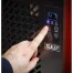 A hand presses the power button on a Sealey 70L Industrial Dehumidifier SDH70—available for hire in Newry—with a digital display reading 47 and multiple control buttons.