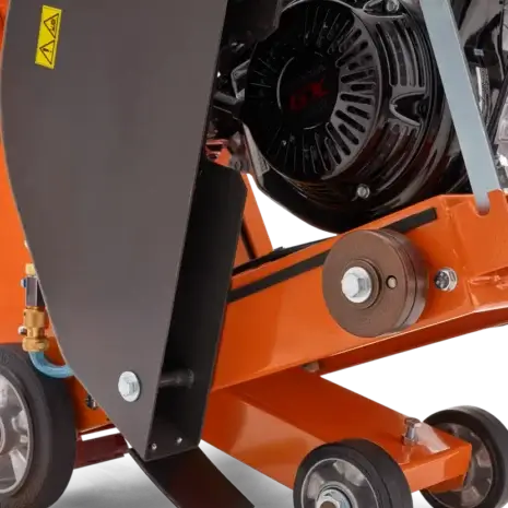 Husqvarna FS 400 LV Floor Saw-3 Close-up of an orange Husqvarna FS 400 LV Floor Saw, available for tool hire in Newry, highlighting its cutting blade, wheels, and engine components.